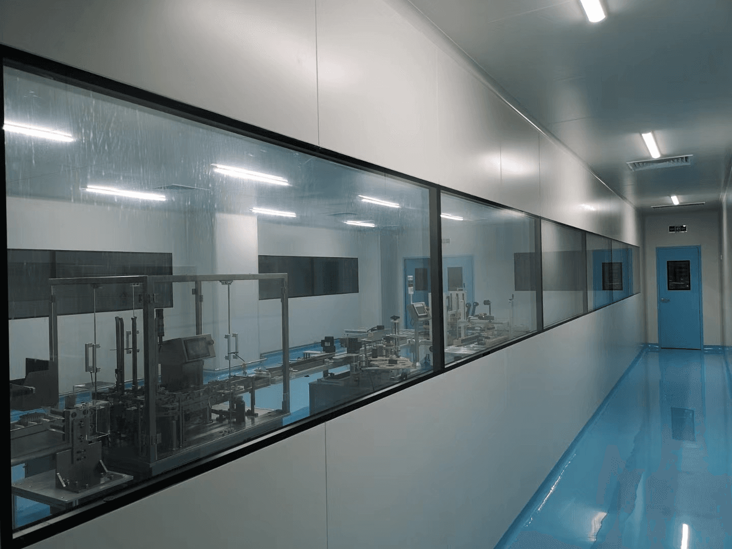 Clean room corridor with glass observation windows overlooking production