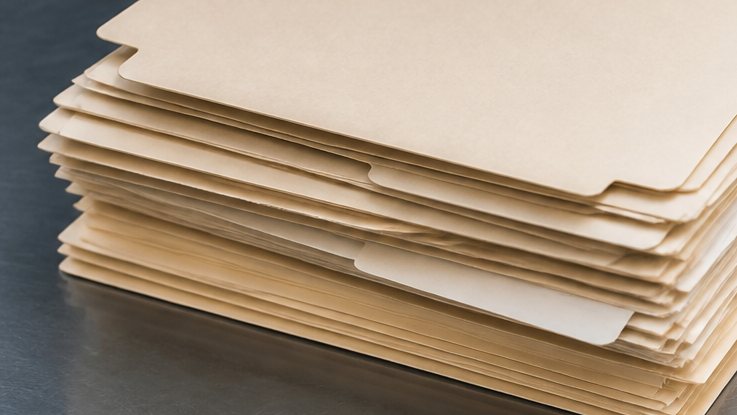 Blank file folders on a metal desk