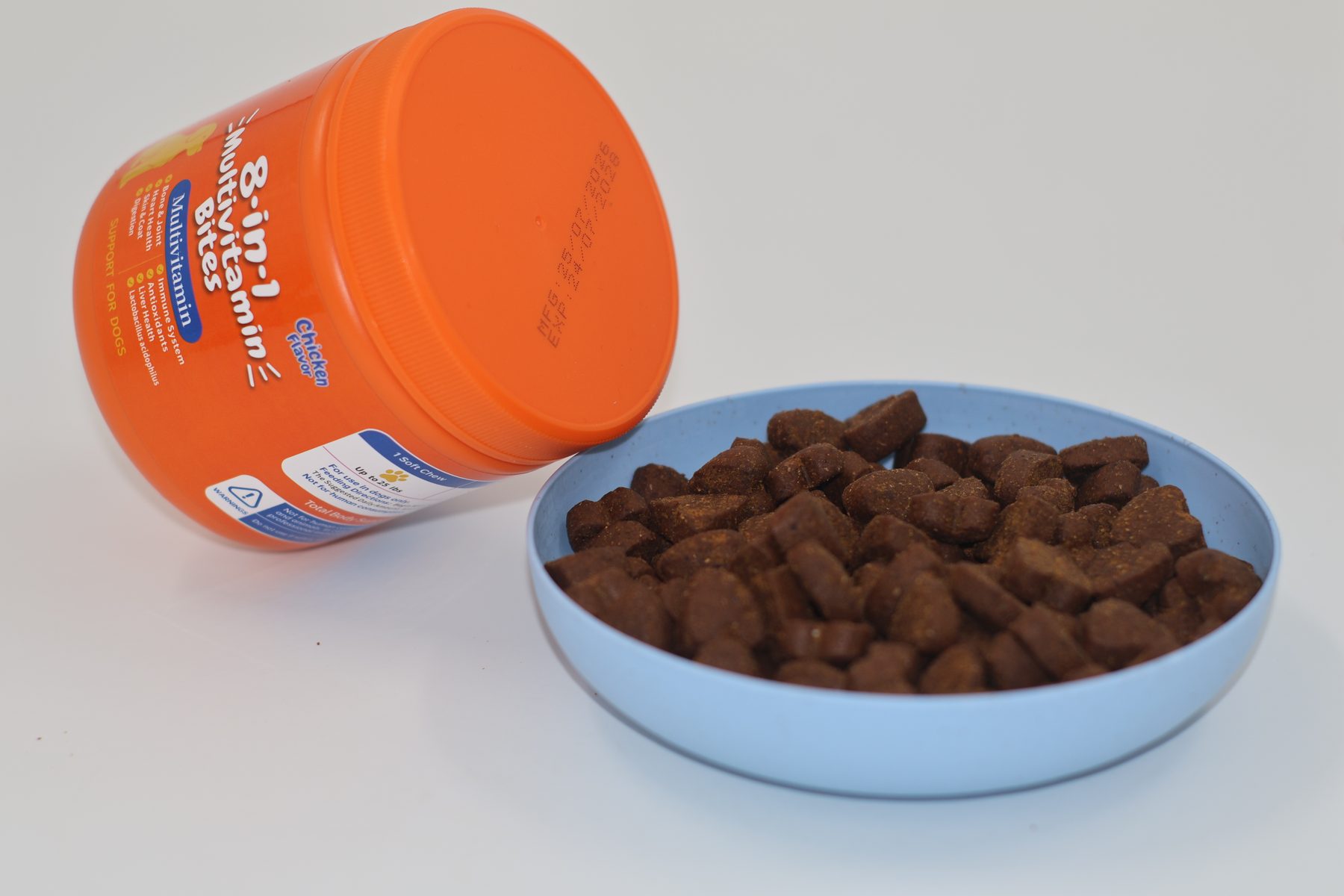 Open 8-in-1 jar with heart chews spilled beside a bowl, the format Amazon photographs